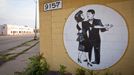 Detroit on the Verge of Bankruptcy May 13th 2012, Hand painted mural of a couple ballroom dancing on a closed dance studio across from a blighted building in Detroit, Michigan. Bankruptcy looms for the city of Detroit after decades of a troubled economy initially caused by the decline of the domestic automobile manufacturing industry.