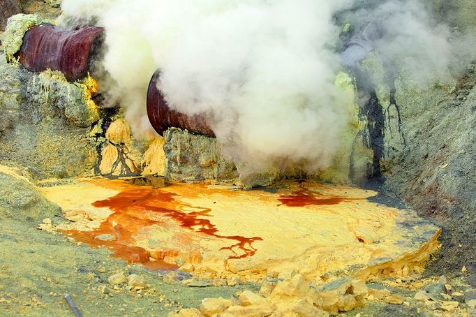 Sulphur Miners - (PICTURED The sulpher miners working in a live volcano.) - And you thought you had a hard day at the office, meet the sulphur miners who work in a live volcano and whose life expectancy is just 30 YEARS OLD. As these sobering pictures show around 200 brave souls toil up to 12 hours a day at the top of Ijen volcano, in Indonesia. The men - who earn just Ł3 a day - carry baskets of hardened yellow sulphur from the crater floor weighing around 70 to 90kg around ten times a day. The toxic air and fumes can be fatal if breathed too long at the mine where the men risk their lives to supply the hellish substance for oil and detergent companies. **NOT FOR SALE IN POLAND OR RUSSIA**