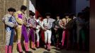 Bullfighters and their assistants stand before the start of a bullfight in The Maestranza bullring in Seville