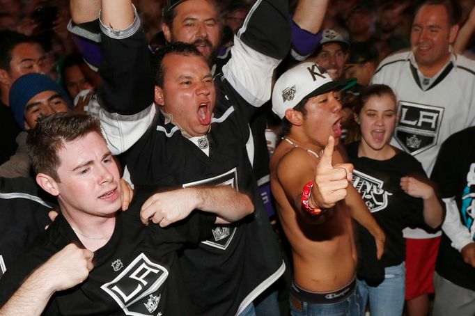 Los Angeles Kings hockey fans celebrate outside Staples Center after the Kings beat the New York Rangers 3-2 in the second overtime to win the Stanley Cup Finals in Los A