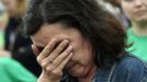 A woman cries as she listens to a speech during a rally in support of the miners locked in the Pozo Candin mine, in Tuilla, near Oviedo, northern Spain, June 16, 2012. Five miners have locked themselves up at the mine in protest at the government's proposal to decrease funding for coal production. REUTERS/Eloy Alonso (SPAIN - Tags: CIVIL UNREST BUSINESS EMPLOYMENT ENERGY) Published: Čer. 16, 2012, 5:26 odp.