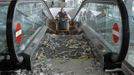 A passenger pushes a trolley up a travelator during a protest by the cleaning staff at Barcelona's airport May 29, 2012. Cleaning staff working for a company which has a contract with the airport demonstrated against pay and benefits cuts made by their employer. REUTERS/Albert Gea (SPAIN - Tags: CIVIL UNREST BUSINESS TRANSPORT) Published: Kvě. 29, 2012, 5:14 odp.