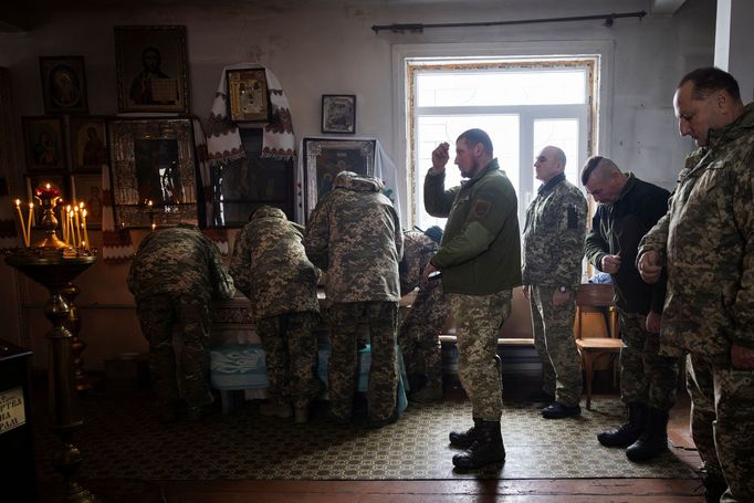 Servicemen attend a mass in an Orthodox church near the front lines in the Donetsk region as Ukrainians prepare to celebrate their first Christmas according to a Western