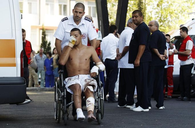 An Israeli survivor is carried on a wheelchair to an ambulance as he leaves a hospital in the city of Burgas, some 400km (249 miles) east of Sofia July 19, 2012, en route to Israel. A suicide bomber committed the attack that killed eight people in a bus transporting Israeli tourists at a Bulgarian airport, the country's interior minister said on Thursday, and Israel accused Iranian-backed Hezbollah militants of responsibility. REUTERS/Stoyan Nenov (BULGARIA - Tags: CRIME LAW TRANSPORT)