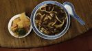 Snake meat is seen in a bowl of snake soup served at a snake soup shop in Hong Kong January 30, 2013. There are scores of people in Hong Kong who have through generations tamed snakes to make soup out of them, a traditional cuisine believed to be good for the health. Yet the people behind providing fresh snakes for the savoury meal thought to speed up the body's blood flow and keep it strong in the cold winter months may be doomed, with young people increasingly reluctant to take on a job they see as hard and dirty. Picture taken January 30, 2013. REUTERS/Bobby Yip (CHINA - Tags: ANIMALS SOCIETY FOOD) Published: Úno. 7, 2013, 2:01 odp.