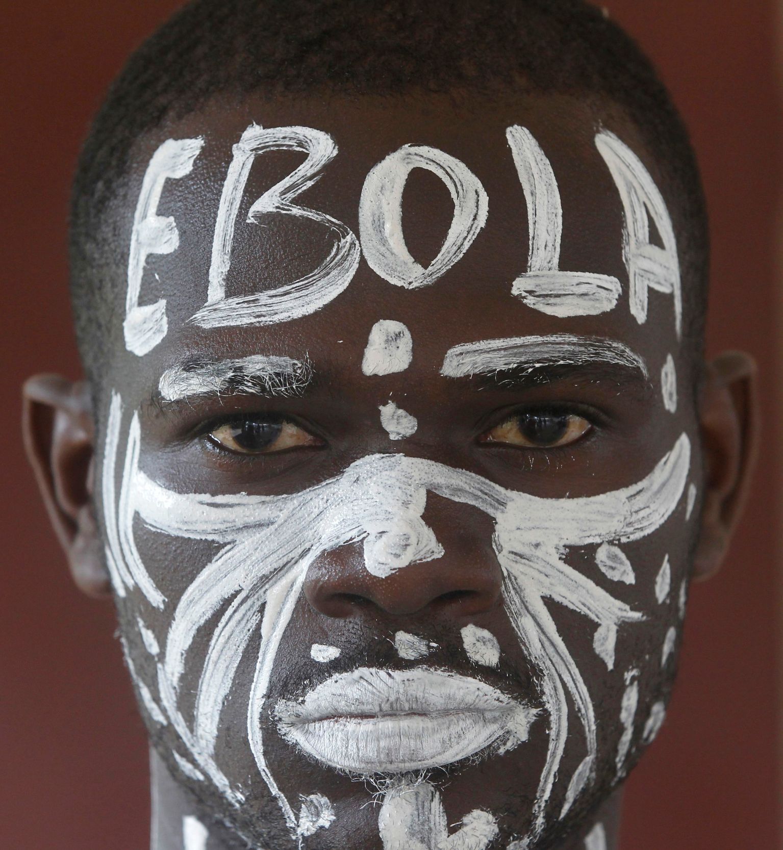 An actor is pictured before a performance during an awareness campaign against Ebola at Anono school in Abidjan
