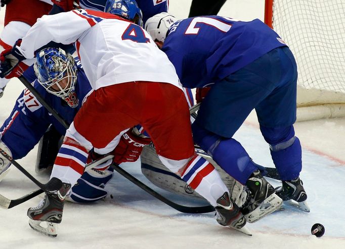 France's goalie Florian Hardy (L) saves in front of Jan Kovar of the Czech Republic (C) during the second period of their men's ice hockey World Championship Group A game