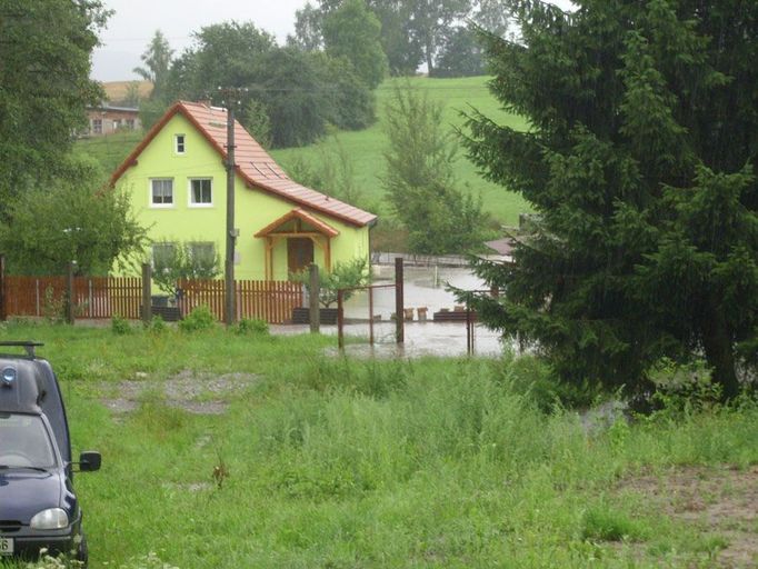 Snímek z Horní Libchavy u České Lípy, kde již od brzkých odpoledních hodin lidé bojují s rozvodněným potůčkem Libchava.