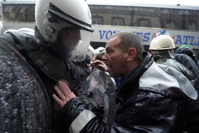 Arcelor Mittal workers from several Liege argue with riot policemen during a demonstration outside the Walloon Region parliament in Namur January 29, 2013. Arcelor Mittal, the world's largest steel producer, plans to shut a coke plant and six finishing lines at its site in Liege, Belgium, affecting 1,300 employees, the group said last week. REUTERS/Laurent Dubrule (BELGIUM - Tags: CIVIL UNREST BUSINESS EMPLOYMENT COMMODITIES) Published: Led. 29, 2013, 2:11 odp.