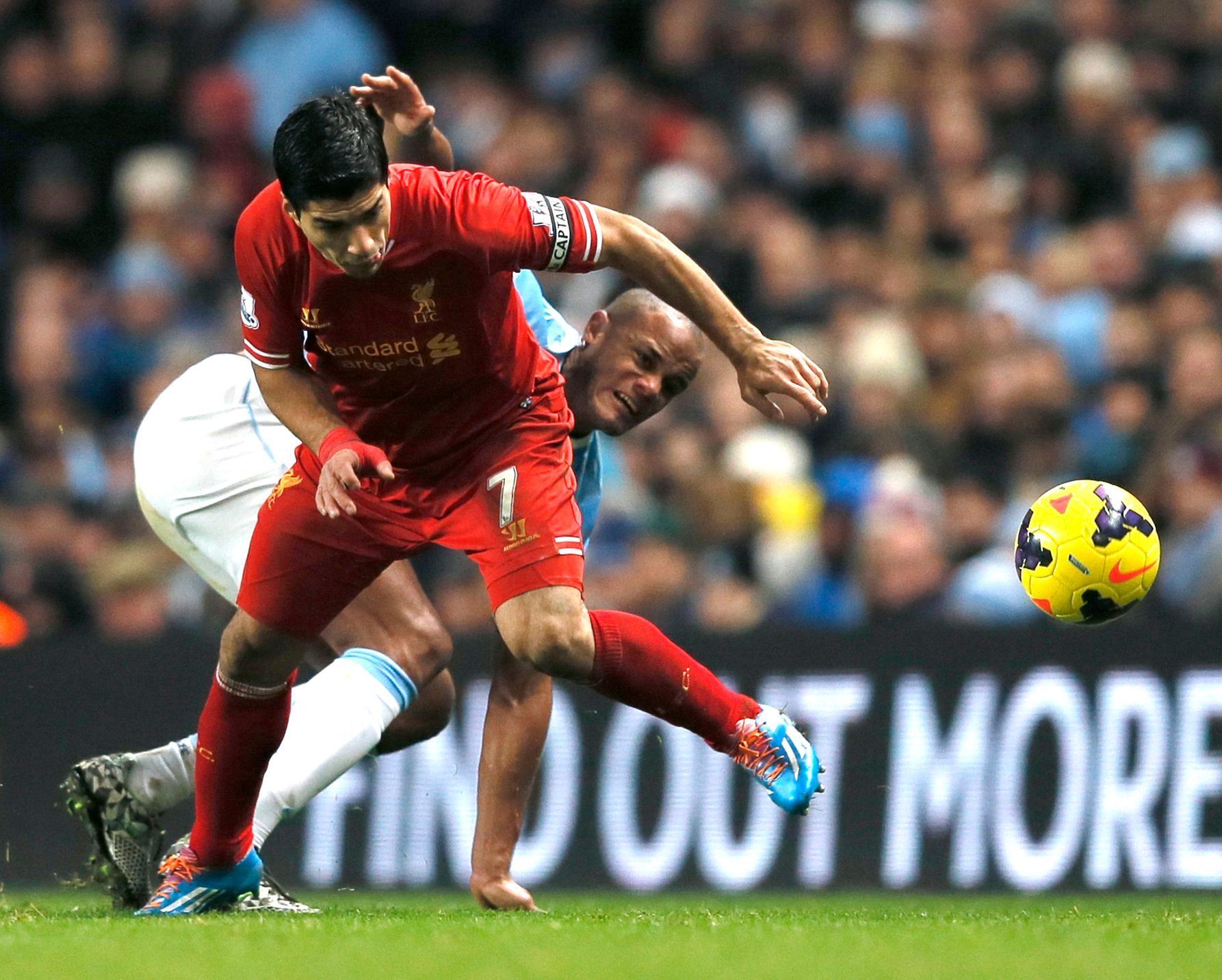 Liverpool's Suarez challenges Manchester City's Kompany during their English Premier League soccer match in Manchester