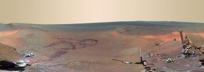 Color Panorama of 'Santa Maria' Crater for Opportunity's Anniversary NASA's Mars Exploration Rover Opportunity is spending the seventh anniversary of its landing on Mars investigating a crater called "Santa Maria," which has a diameter about the length of a football field. This scene looks eastward across the crater. Portions of the rim of a much larger crater, Endurance, appear on the horizon. The panorama spans 125 compass degrees, from north-northwest on the left to south-southwest on the right. It has been assembled from multiple frames taken by the panoramic camera (Pancam) on Opportunity during the 2,453rd and 2,454th Martian days, or sols, of the rover's work on Mars (Dec. 18 and 19, 2010). Opportunity landed in the Meridiani Planum region of Mars on Jan. 24, 2004, Universal Time (Jan. 25, Pacific Time) for a mission originally planned to last for three months. Since that prime mission, the rover has continued to work in bonus-time extended missions. Both Opportunity and its twin, Spirit, have made important discoveries about wet environments on ancient Mars that may have been favorable for supporting microbial life. By mid-January 2011, Opportunity reached a location at the southeastern edge of Santa Maria crater. The rover team developed plans for Opportunity to spend a few weeks investigating rocks at that site during solar conjunction, a period when communications between Earth and Mars are curtailed because the sun is almost directly between the two planets. After completion of its work at Santa Maria, the rover will resume a long-term trek toward Endeavour. This view combines images taken through three different Pancam filters admitting light with wavelengths centered at 753 nanometers (near infrared), 535 nanometers (green) and 432 nanometers (violet). This "natural color" is the rover team's best estimate of what the scene would look like if we were there and able to see it with our own eyes. Seams have been eliminated from the sky portion of the mosaic to better simulate the vista a person standing on Mars would see. Image Credit: NASA/JPL-Caltech/Cornell/ASU