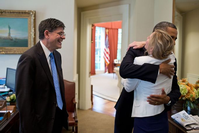 June 28, 2012 "This was the day that the U.S. Supreme Court ruled on the Affordable Health Care Act. Before the President came downstairs from the residence that morning, the split-screen television in the Outer Oval Office was flashing bulletins that the Court had overturned the act. Kathy Ruemmler, the White House counsel, came rushing in and told me and the President's secretary just the opposite. Kathy then departed and a few minutes later the President arrived at the Oval and saw the same inaccurate information on the television. Kathy soon reappeared to tell the President that the Court had indeed upheld the Act, and that the TV reports had it wrong. He then gave her a big hug, as Chief of Staff Jack Lew watched at left."