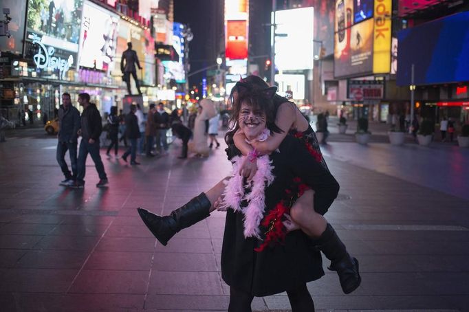 Revellers dressed up for Halloween play around in Times Square, New York November 1, 2012. Mega-storm Sandy played Wicked Witch on Wednesday, postponing Halloween for millions of disappointed East Coast children warned not to trick or treat amid dangling electrical wires and trees uprooted by the deadly weather. REUTERS/Adrees Latif (UNITED STATES - Tags: SOCIETY DISASTER ENVIRONMENT) Published: Lis. 1, 2012, 8:40 dop.