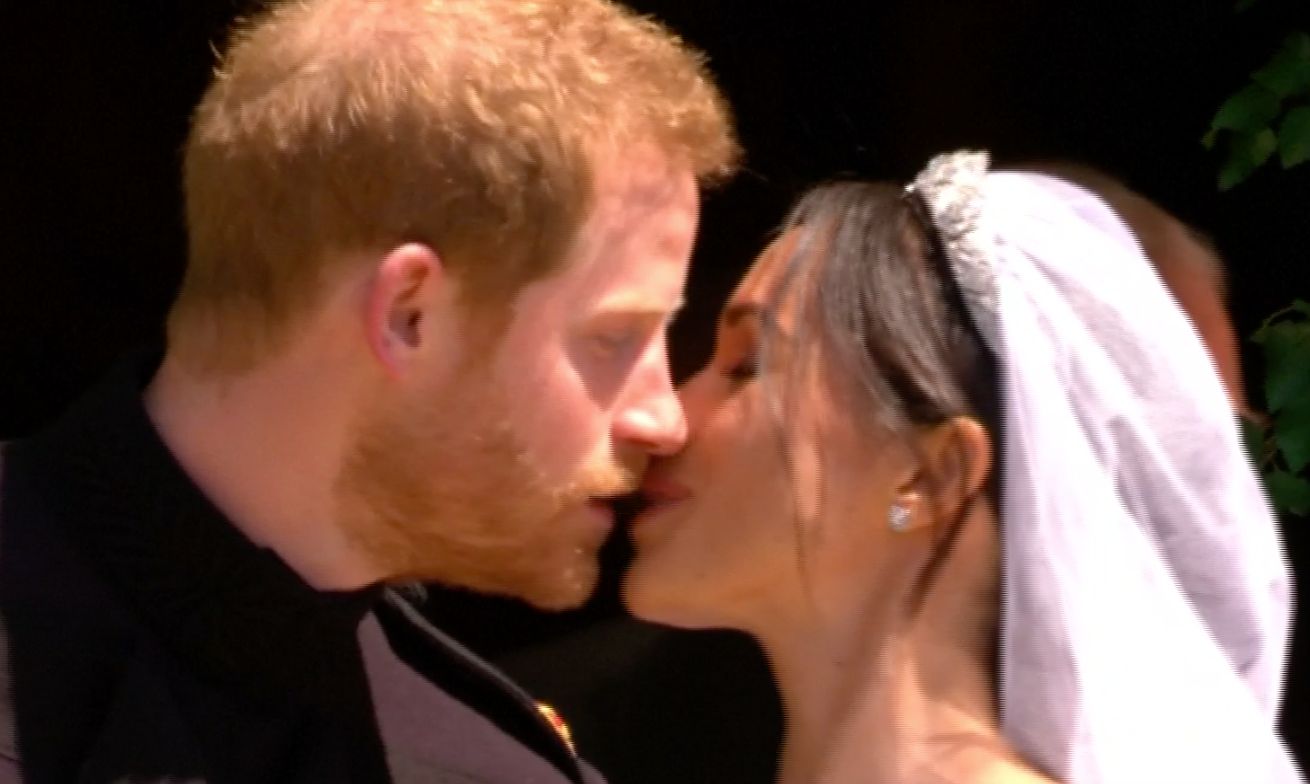 Princ Harry a Meghan Markleová se líbají po svatebním obřadu.