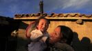 Marathon runner Gladys Tejeda, the first Peruvian athlete who qualified for the 2012 London Olympic Games, holds her niece Ariana at her home in the Andean province of Junin May 13, 2012. A private company will take Tejeda's mother Marcelina Pucuhuaranga, 69, to London as part of the "Thank you Mom" program. For Pucuhuaranga, who received her first passport, it will be the first time travelling out of Peru. The program will take about 120 mothers of different athletes around the world to attend the games. Tejeda, the youngest of nine children, returned to her hometown to visit her mother and to focus on training where she will run more than 20 km every day in the highlands (over 4,105 meters above sea level). Picture taken May 13, 2012. REUTERS/Pilar Olivares (PERU - Tags: SPORT ATHLETICS OLYMPICS) Published: Kvě. 17, 2012, 5:55 odp.