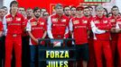 Members of Ferrari Formula One team pose with a sign in support of Marussia Formula One driver Jules Bianchi of France before the first Russian Grand Prix in Sochi Octobe