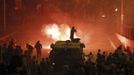 A riot police officer fires rubber bullets at members of the Muslim Brotherhood and supporters of ousted Egyptian President Mohamed Mursi in Cairo