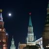 The supermoon rises over the stars of Moscow's Kremlin towers in Moscow