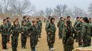 Female fighters of the Kurdish People's Protection Units (YPG) receive instructions at a military camp in Ras a-Ain January 30, 2015. Picture taken January 30, 2015.