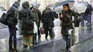 People wait at a bus stop during a snow storm in New York's financial district, November 7, 2012. A wintry storm dropped snow on the Northeast and threatened to bring dangerous winds and flooding to a region still climbing out from the devastation of superstorm Sandy. REUTERS/Brendan McDermid (UNITED STATES - Tags: DISASTER ENVIRONMENT TRANSPORT) Published: Lis. 8, 2012, 12:03 dop.