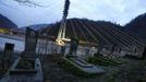 A graveyard is seen next to a bridge for the new highway connecting Sochi, the host city for the Sochi 2014 Winter Olympics, and the winter sport resort of Krasnaya Polyana, February 18, 2013. Although many complexes and venues in the Black Sea resort of Sochi mostly resemble building sites that are still under construction, there is nothing to suggest any concern over readiness. Construction will be completed by August 2013 according to organizers. The Sochi 2014 Winter Olympics opens on February 7, 2014. REUTERS/Kai Pfaffenbach (RUSSIA - Tags: BUSINESS CONSTRUCTION CITYSCAPE ENVIRONMENT SPORT OLYMPICS) Published: Úno. 18, 2013, 7:26 odp.