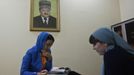 An employee of a memorial complex devoted to former Chechen leader Akhmad Kadyrov signs documents in the Chechen capital Grozny April 26, 2013. The naming of two Chechens, Dzhokhar and Tamerlan Tsarnaev, as suspects in the Boston Marathon bombings has put Chechnya - the former site of a bloody separatist insurgency - back on the world's front pages. Chechnya appears almost miraculously reborn. The streets have been rebuilt. Walls riddled with bullet holes are long gone. New high rise buildings soar into the sky. Spotless playgrounds are packed with children. A giant marble mosque glimmers in the night. Yet, scratch the surface and the miracle is less impressive than it seems. Behind closed doors, people speak of a warped and oppressive place, run by a Kremlin-imposed leader through fear. Picture taken April 26, 2013. REUTERS/Maxim Shemetov (RUSSIA - Tags: SOCIETY POLITICS) ATTENTION EDITORS: PICTURE 28 OF 40 FOR PACKAGE 'INSIDE MODERN CHECHNYA'. SEARCH 'REBUILDING CHECHNYA' FOR ALL IMAGES Published: Kvě. 1, 2013, 8:11 dop.