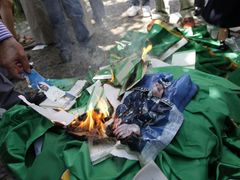 Před libyjskou ambasádou v Ankaře lidé pálili Kaddáfího fotografie.
