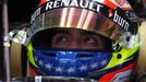 Lotus Formula One driver Pastor Maldonado of Venezuela waits in his car during the first practice session of the Malaysian F1 Grand Prix at Sepang International Circuit o