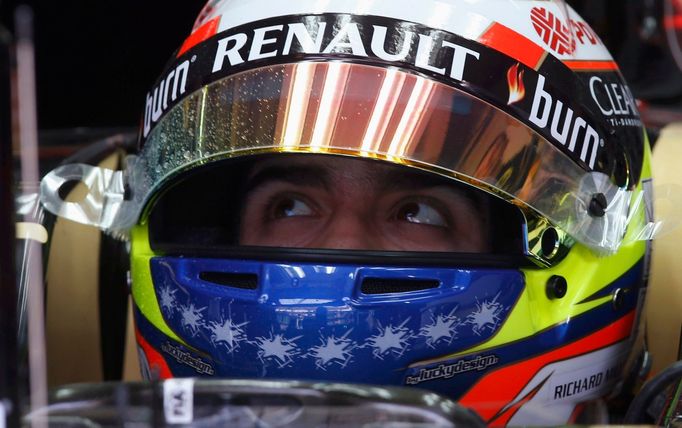 Lotus Formula One driver Pastor Maldonado of Venezuela waits in his car during the first practice session of the Malaysian F1 Grand Prix at Sepang International Circuit o