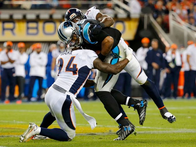 Carolina Panthers' quarterback Cam Newton is sacked by Denver Broncos' DeMarcus Ware (94)