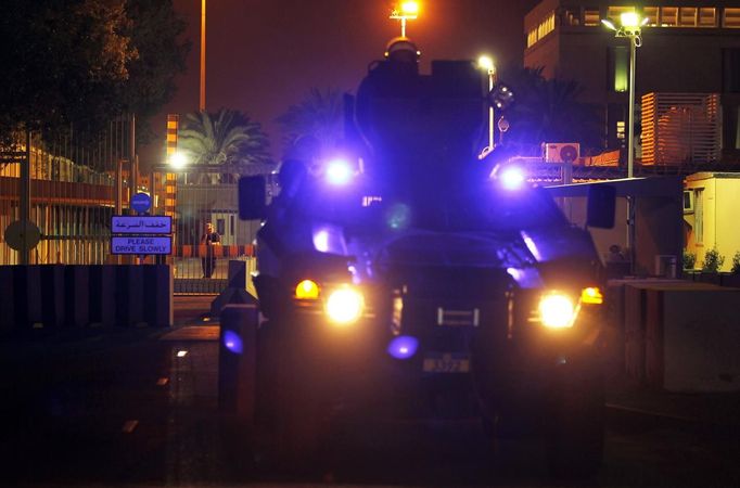 An internal security personnel of the U.S. embassy stands behind a fenced gate as a Bahraini riot police armoured personnel carrier guards the embassy in Manama September 13, 2012. Protesters tried to march on the U.S. embassy in Manama on Thursday to protest against a U.S. film that is said to insult the Prophet Mohammad, but heavy security presence prevented them from reaching the embassy.