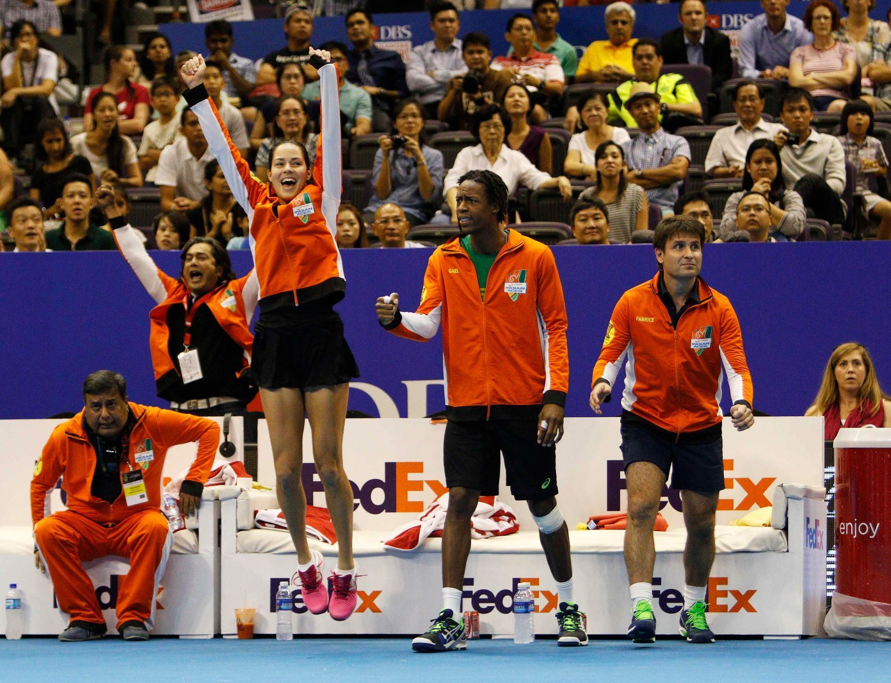 Team Micromax Indian Aces' Ivanovic of Serbia, Gael Monfils of France and Santoro of France react courtside during their mixed doubles match at the International Premier Tennis League (IPTL) in Singap
