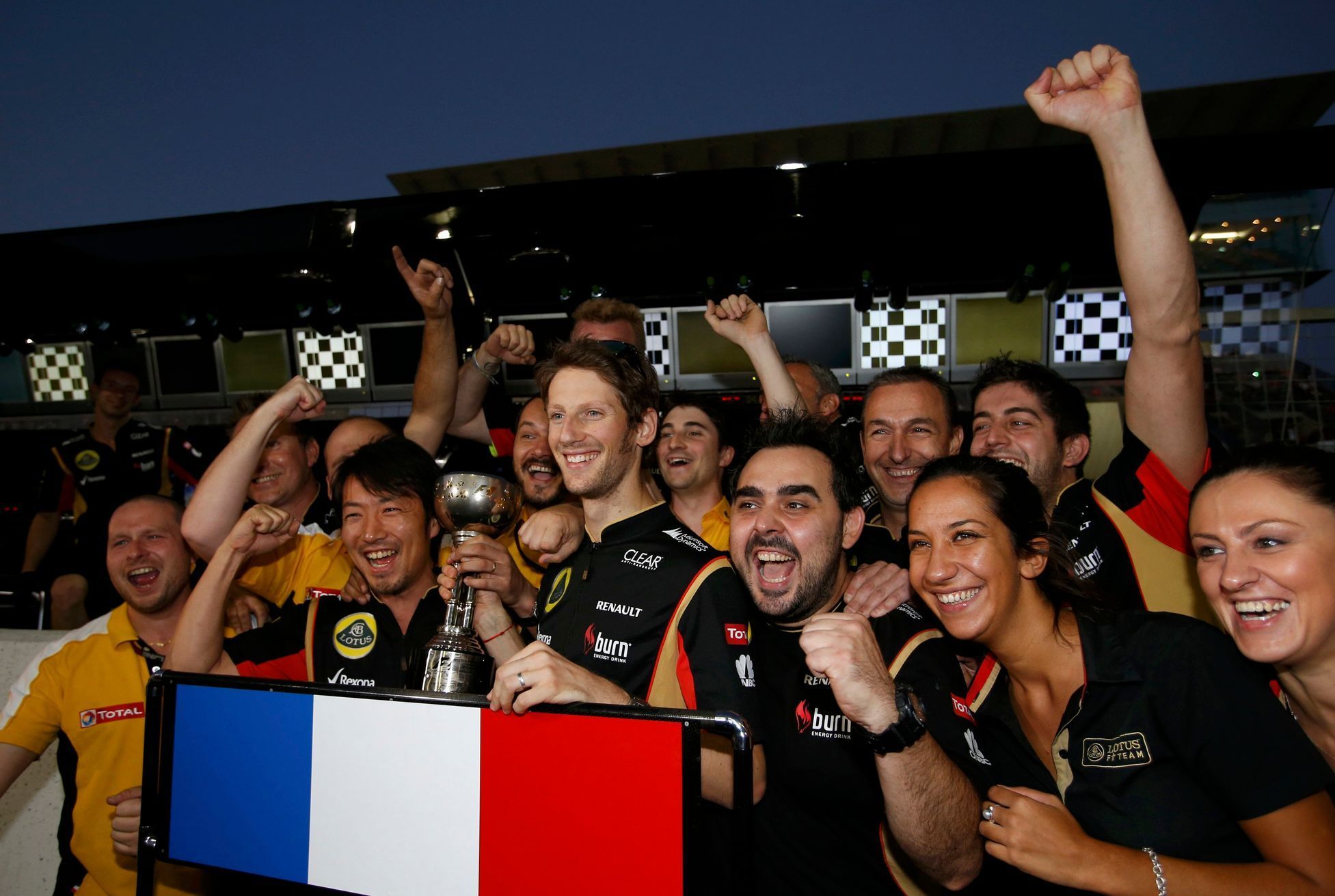 Lotus Formula One driver Grosjean of France celebrates his third place finish after the Japanese F1 Grand Prix at the Suzuka circuit