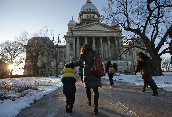 Theresa Volpe (2nd L) arrives with her son Jaidon Santos-Volpe (L) and they are joined by her partner Mercedes Santos (R) to attend a Senate Executive Committee hearing on same-sex marriages at the Illinois State Legislature in Springfield, Illinois, January 2, 2013. Picture taken on January 2, 2013. REUTERS/Jim Young (UNITED STATES - Tags: SOCIETY) Published: Bře. 25, 2013, 6:07 odp.