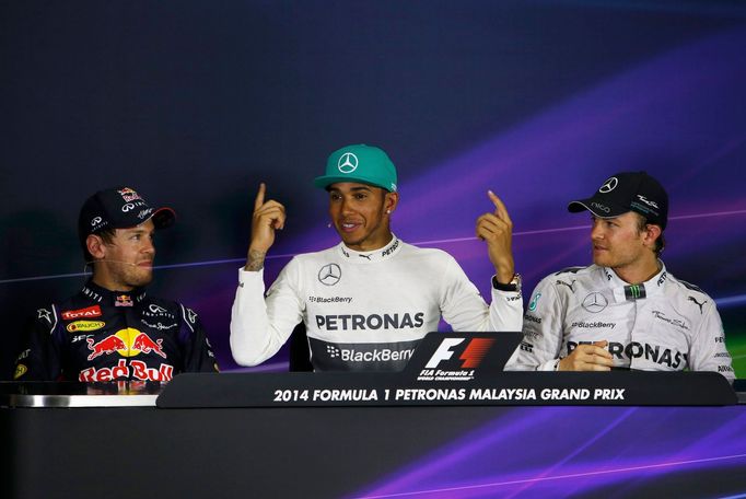 Mercedes Formula One driver Lewis Hamilton of Britain (C), seated between Red Bull Formula One driver Sebastian Vettel of Germany (L) and Mercedes Formula One driver Nico