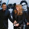 Musician and singer-songwriter Springsteen hands his wife Scialfa of E Street Band her award after band was inducted during 29th annual Rock and Roll Hall of Fame Induction Ceremony in Brooklyn, New Y