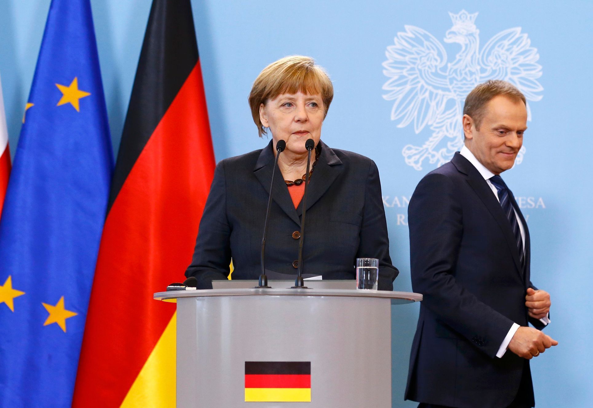 German Chancellor Merkel prepares to address to media as Polish PM Tusk looks on after their meeting in Warsaw