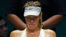 Maria Sharapova of Russia rests in between games in the second set against Petra Kvitova of the Czech Republic during their WTA Finals tennis match at the Singapore Indoo