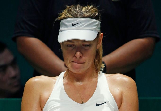 Maria Sharapova of Russia rests in between games in the second set against Petra Kvitova of the Czech Republic during their WTA Finals tennis match at the Singapore Indoo