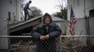 Paul Hernandez poses for a photograph in his front yard as a worker removes the collapsed remains of a portion of his home destroyed when Hurricane Sandy struck in New Dorp Beach, Staten Island November 14, 2012. Hernandez said he and other residents were angry at New York city officials for not doing more to protect their neighbourhood from the ocean and the prospect of flooding. Picture taken November 14, 2012. REUTERS/Mike Segar (UNITED STATES - Tags: DISASTER ENVIRONMENT TPX IMAGES OF THE DAY) ATTENTION EDITORS PICTURE 13 19 FOR PACKAGE 'SURVIVING SANDY' SEARCH 'SEGAR SANDY' FOR ALL PICTURES Published: Lis. 20, 2012, 3:31 odp.