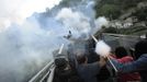 Coal miners fire rockets during a clash with Spanish national riot police in the surroundings of the "El Soton" coal mine in El Entrego, near Oviedo, northern Spain June 15, 2012. The miners were protesting against the government's proposal to decrease funding for coal production. REUTERS/Eloy Alonso (SPAIN - Tags: CIVIL UNREST BUSINESS EMPLOYMENT ENERGY) Published: Čer. 15, 2012, 11:43 dop.