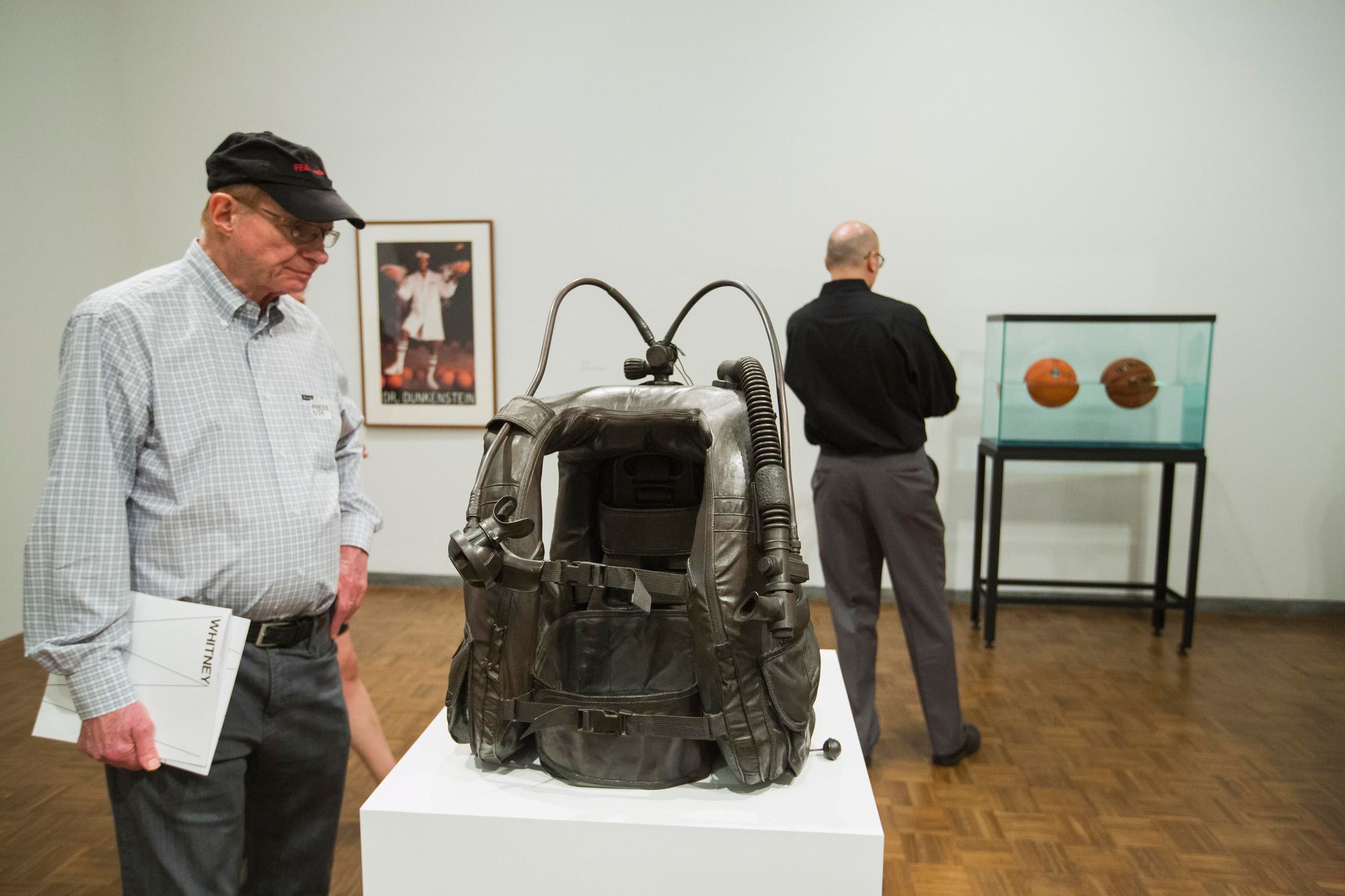 A man inspects the sculpture Aqualung during a media preview before the opening of a Jeff Koons retrospective at the Whitney Museum of American Art in New York