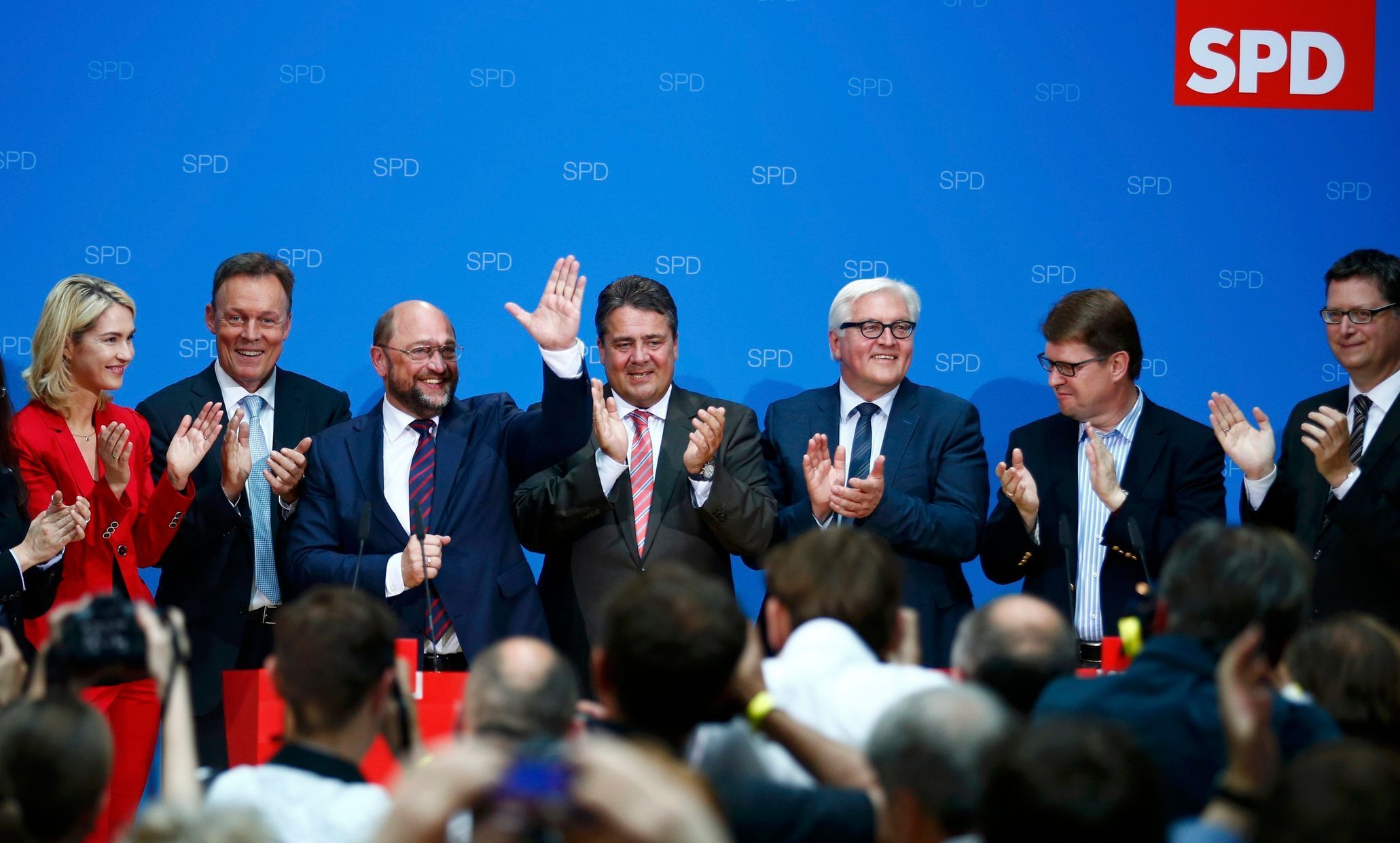 Schulz, candidate for European Commission president of Germany's SPD, gestures as he receives applause from SPD chairman Gabriel, Foreign Minister Steinmeier and other party members upon first exit po