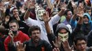 Demonstrators sing "These are our weapons" as they hold their hands up after riot police charged them outside the Spanish parliament in Madrid, September 25, 2012. Protesters clashed with police in Spain's capital on Tuesday as the government prepares a new round of unpopular austerity measures for the 2013 budget that will be announced on Thursday. REUTERS/Susana Vera (SPAIN - Tags: CIVIL UNREST BUSINESS POLITICS) Published: Zář. 25, 2012, 9:35 odp.