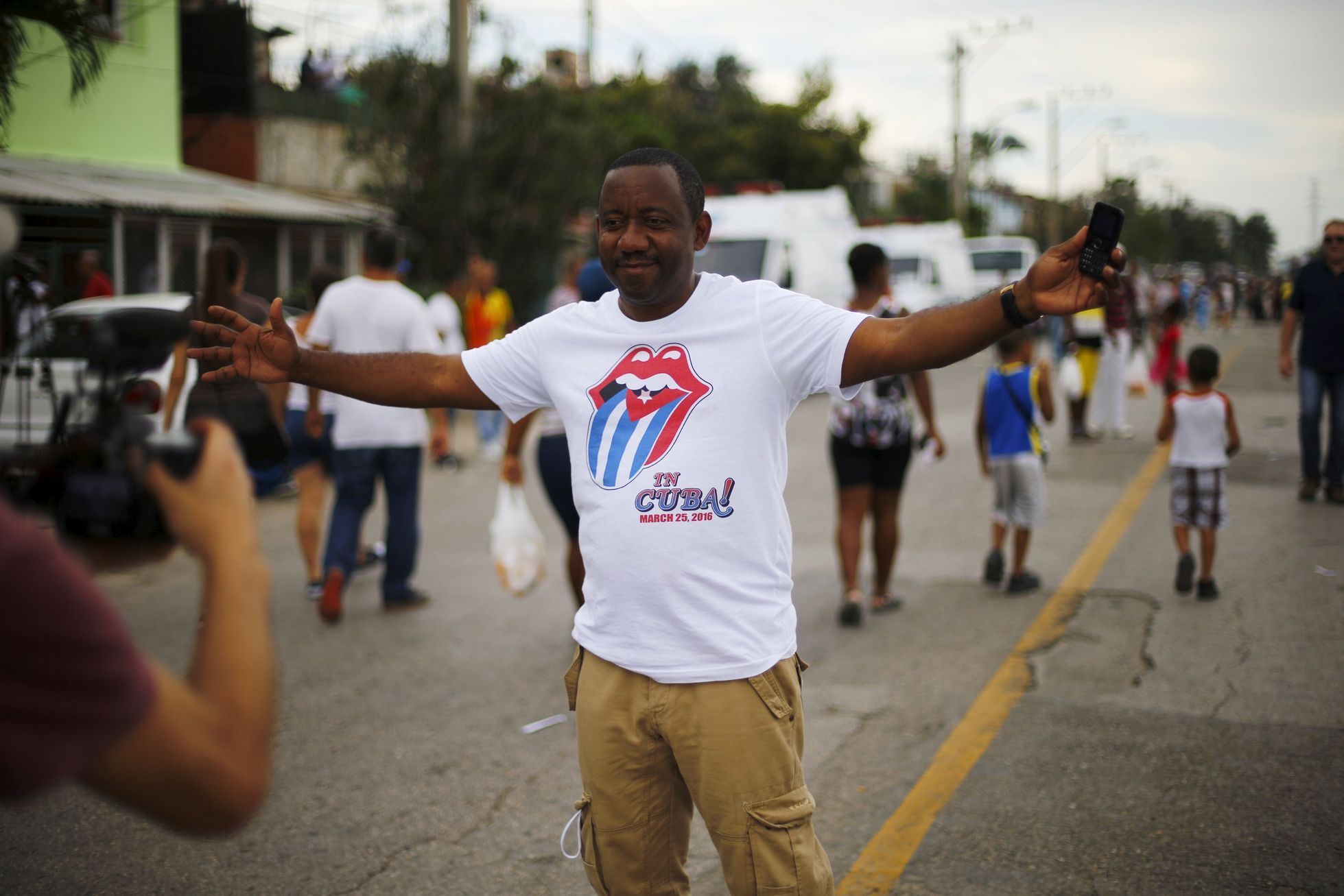 A fan poses outside the Ciudad Deportiva de la Habana sports complex where the Rolling Stones' free outdoor concert will take place today in Havana