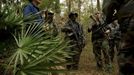 Members of the North Florida Survival Group listen as their leader critiques their performance during an enemy contact drill training exercise in Old Town, Florida, December 8, 2012.The group trains children and adults alike to handle weapons and survive in the wild. The group passionately supports the right of U.S. citizens to bear arms and its website states that it aims to teach "patriots to survive in order to protect and defend our Constitution against all enemy threats". Picture taken December 8, 2013. REUTERS/Brian Blanco (UNITED STATES - Tags: SOCIETY POLITICS) ATTENTION EDITORS: PICTURE 13 OF 20 FOR PACKAGE 'TRAINING CHILD SURVIVALISTS' SEARCH 'FLORIDA SURVIVAL' FOR ALL IMAGES Published: Úno. 22, 2013, 1:01 odp.