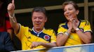 Colombia's President Juan Manuel Santos gestures next to his wife Maria Clemencia during the team's 2014 World Cup Group C soccer match against Ivory Coast at the Brasili