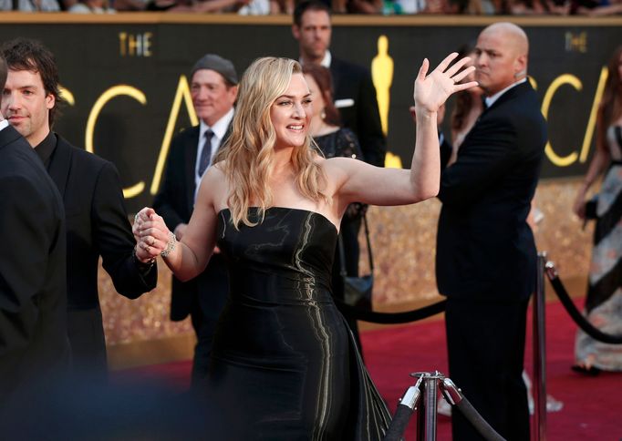 Kate Winslet, nominated for Best Supporting Actress for her role in &quot;Steve Jobs&quot;, wearing a strapless, shiny black Ralph Lauren gown, poses as she arrives at th