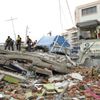 Police officers stand on debris after an earthquake struck off Ecuador's Pacific coast, at Tarqui neighborhood in Manta