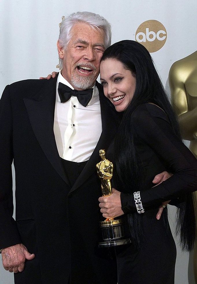 ames Coburn with Angelina Jolie embrace at the Academy Awards presentation 26 March 2000. Jolie won Best Supporting Actress for her role in "Girl, Interupted". (ELECTRONIC IMAGE)